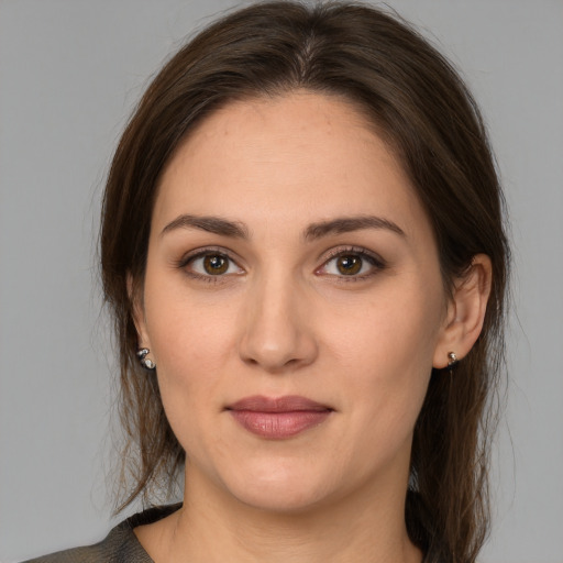 Joyful white young-adult female with medium  brown hair and brown eyes