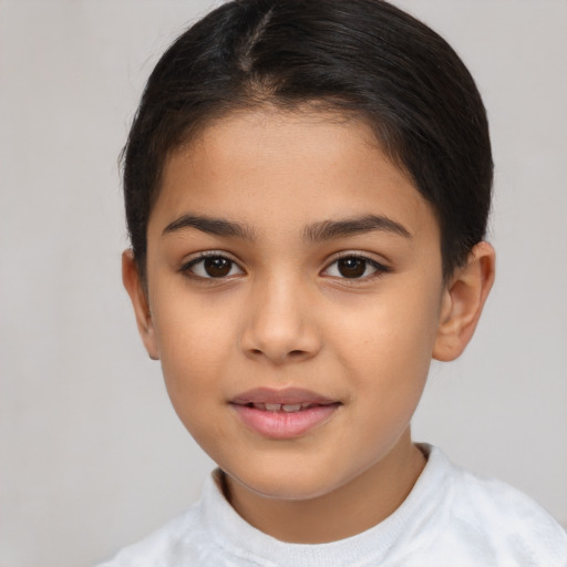 Joyful latino child female with short  brown hair and brown eyes