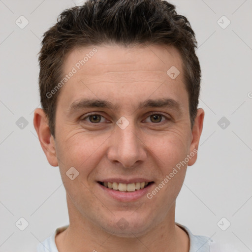 Joyful white young-adult male with short  brown hair and brown eyes