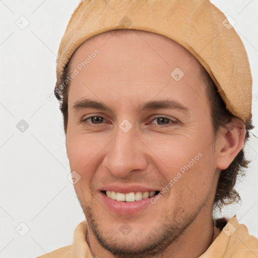 Joyful white young-adult male with short  brown hair and brown eyes