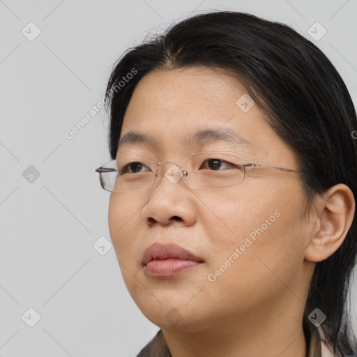 Neutral asian adult female with medium  brown hair and brown eyes