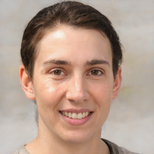 Joyful white young-adult female with short  brown hair and brown eyes