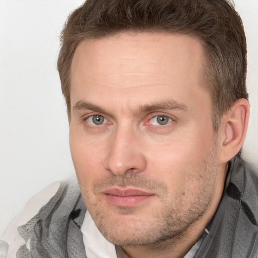 Joyful white adult male with short  brown hair and grey eyes