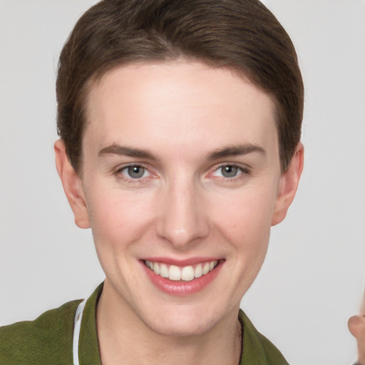 Joyful white young-adult female with short  brown hair and grey eyes