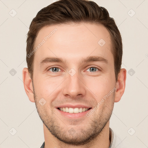 Joyful white young-adult male with short  brown hair and grey eyes