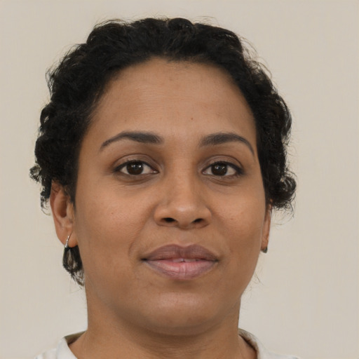 Joyful latino adult female with short  brown hair and brown eyes