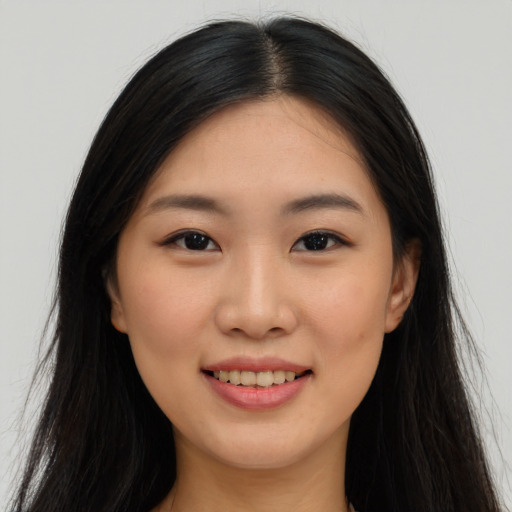 Joyful asian young-adult female with long  black hair and brown eyes