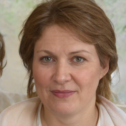 Joyful white adult female with medium  brown hair and blue eyes