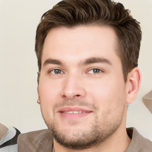 Joyful white young-adult male with short  brown hair and brown eyes