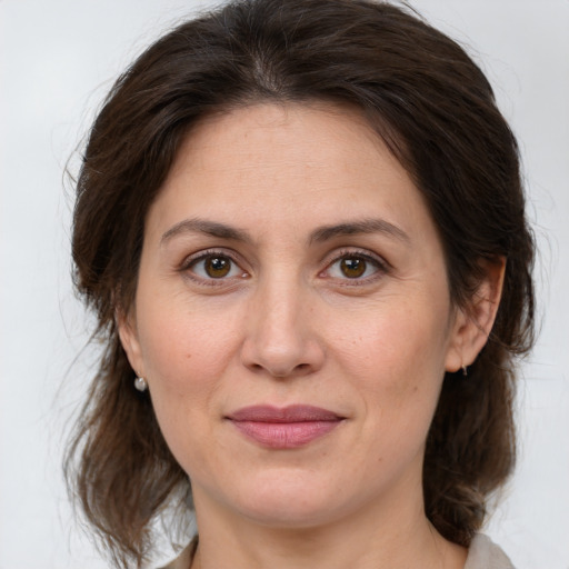 Joyful white adult female with medium  brown hair and brown eyes