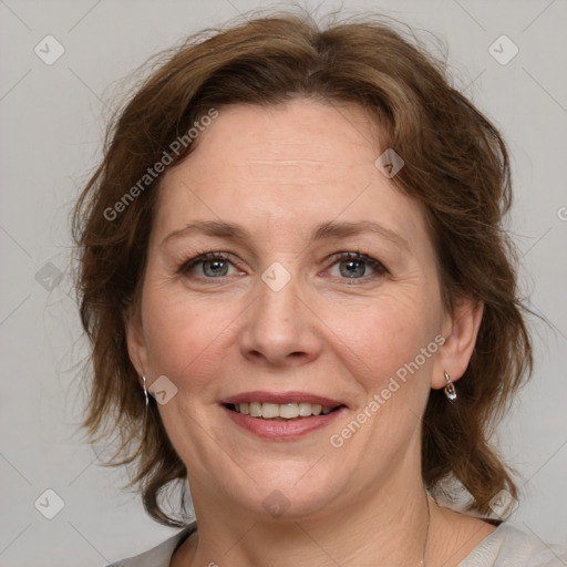 Joyful white adult female with medium  brown hair and grey eyes