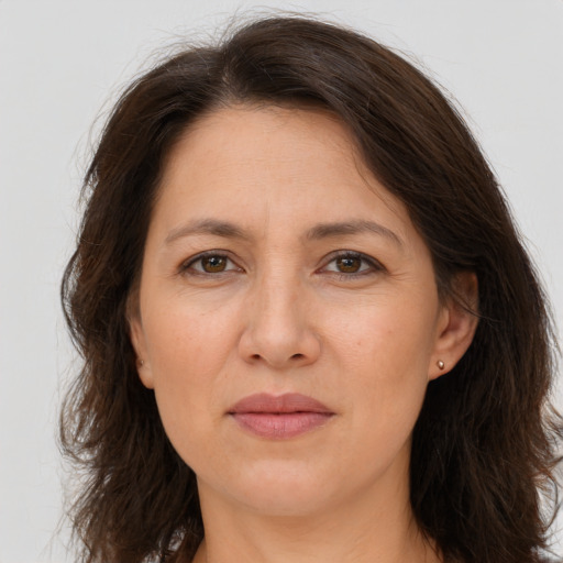 Joyful white adult female with long  brown hair and brown eyes