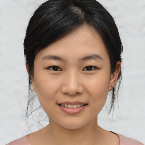 Joyful asian young-adult female with medium  brown hair and brown eyes
