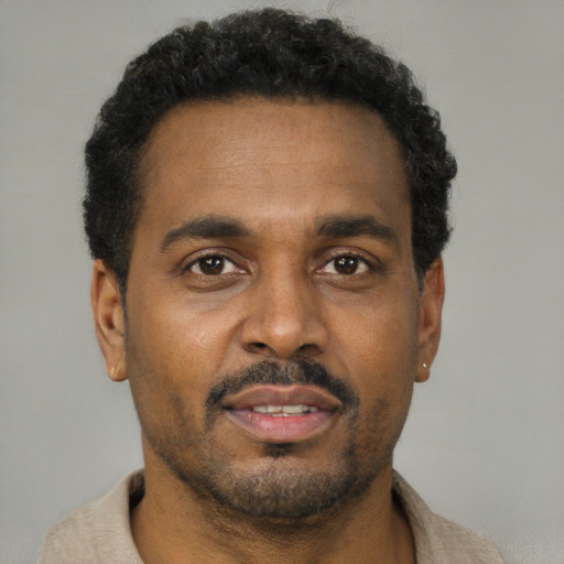 Neutral latino adult male with short  brown hair and brown eyes