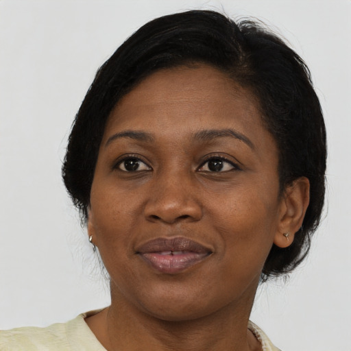 Joyful black adult female with medium  brown hair and brown eyes