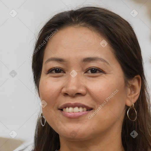 Joyful white adult female with long  brown hair and brown eyes