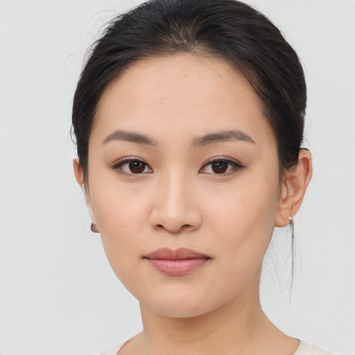 Joyful asian young-adult female with medium  brown hair and brown eyes