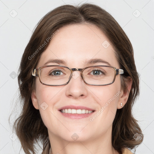 Joyful white adult female with medium  brown hair and blue eyes