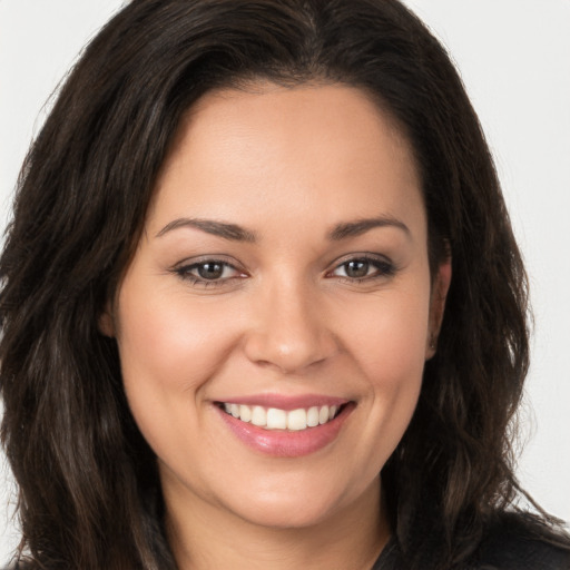 Joyful white young-adult female with long  brown hair and brown eyes