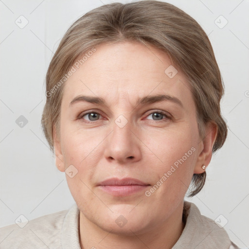 Joyful white adult female with medium  brown hair and grey eyes