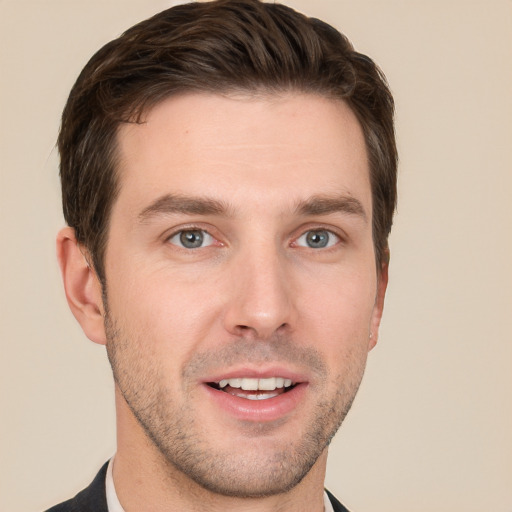 Joyful white young-adult male with short  brown hair and grey eyes