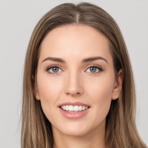 Joyful white young-adult female with long  brown hair and grey eyes