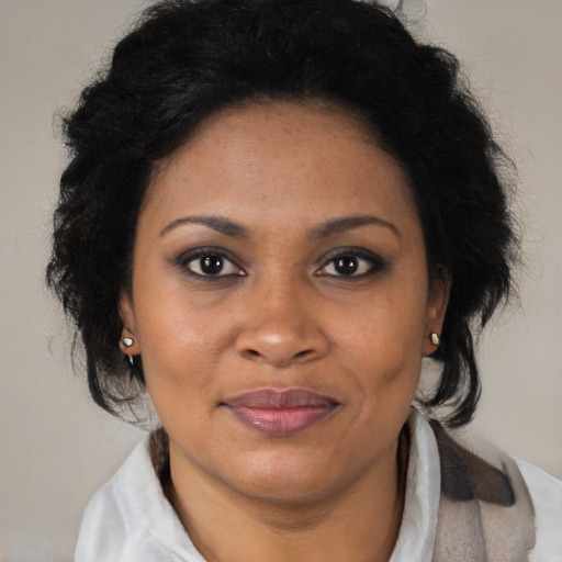 Joyful black adult female with medium  brown hair and brown eyes