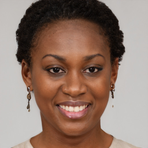 Joyful black young-adult female with short  brown hair and brown eyes