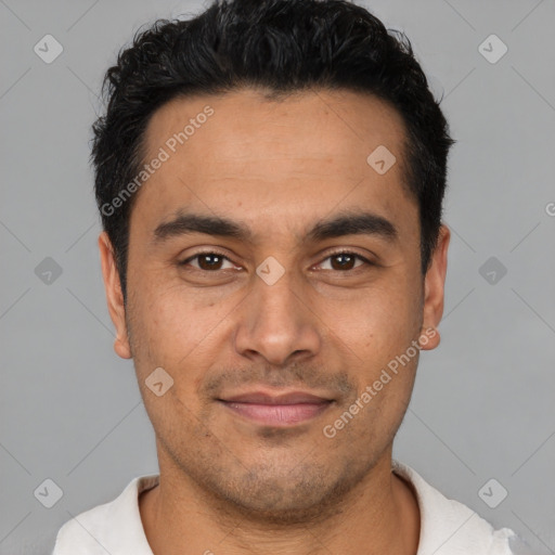 Joyful latino young-adult male with short  black hair and brown eyes