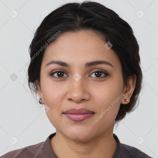 Joyful latino young-adult female with medium  brown hair and brown eyes