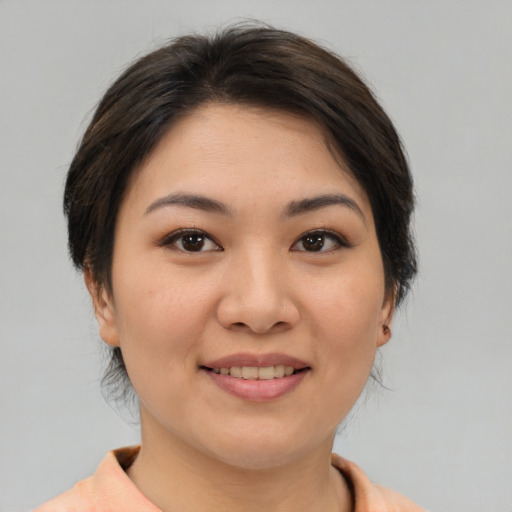 Joyful asian young-adult female with medium  brown hair and brown eyes