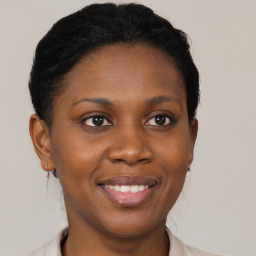 Joyful black young-adult female with short  brown hair and brown eyes