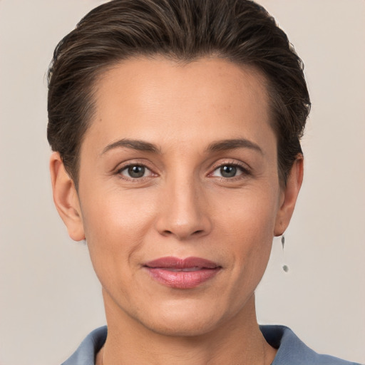 Joyful white adult female with short  brown hair and grey eyes