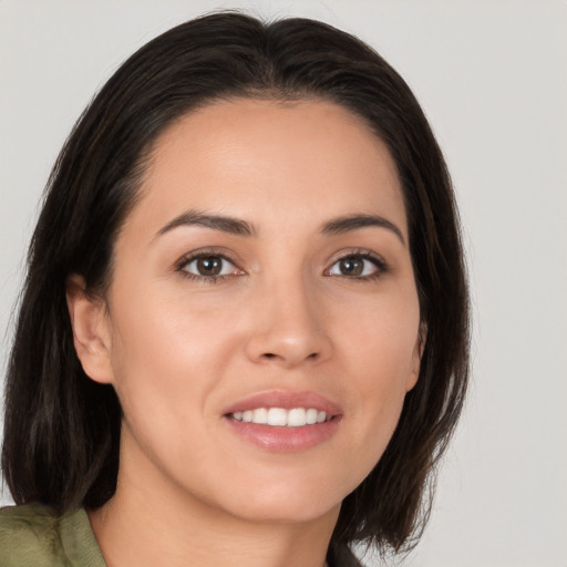 Joyful white young-adult female with medium  brown hair and brown eyes