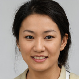 Joyful asian young-adult female with medium  brown hair and brown eyes