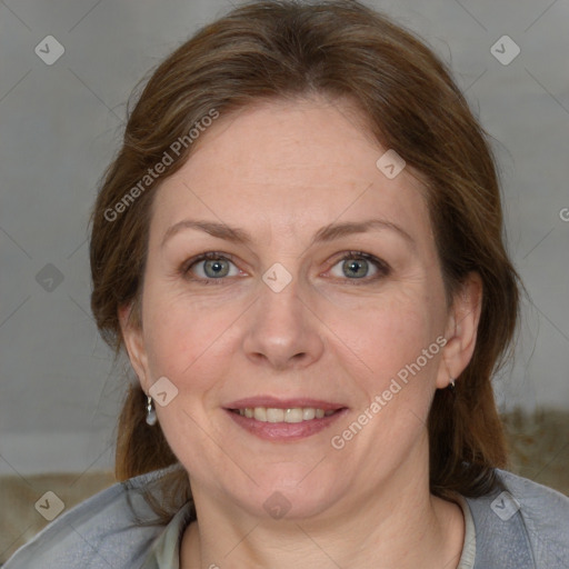 Joyful white adult female with medium  brown hair and blue eyes