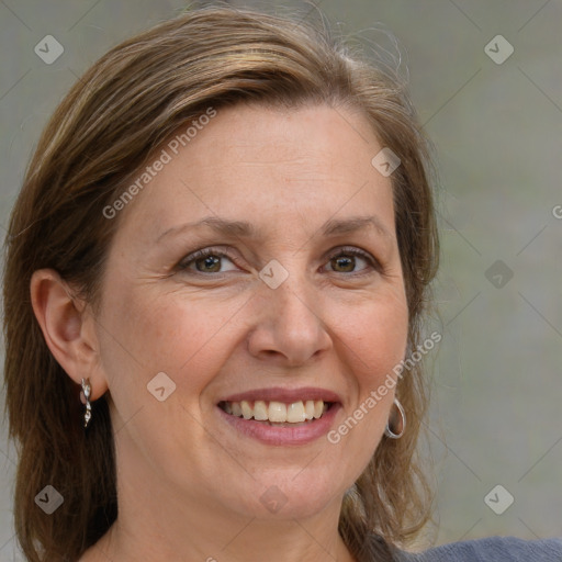 Joyful white adult female with medium  brown hair and blue eyes