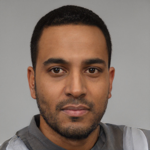 Neutral latino young-adult male with short  black hair and brown eyes