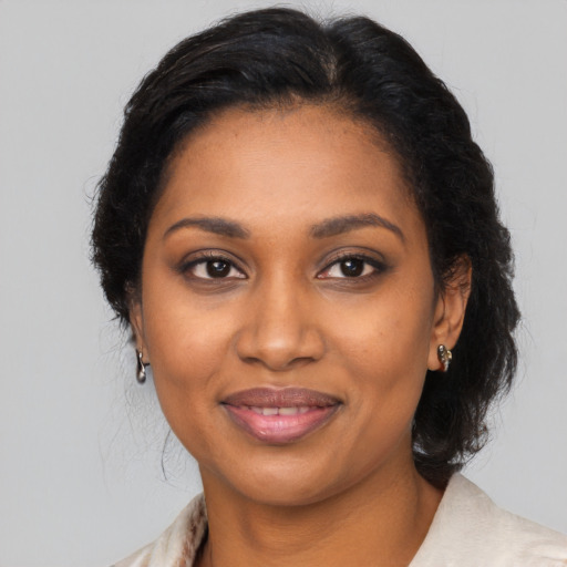 Joyful black young-adult female with long  brown hair and brown eyes