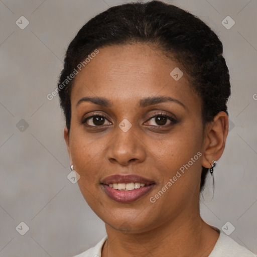 Joyful black young-adult female with short  brown hair and brown eyes