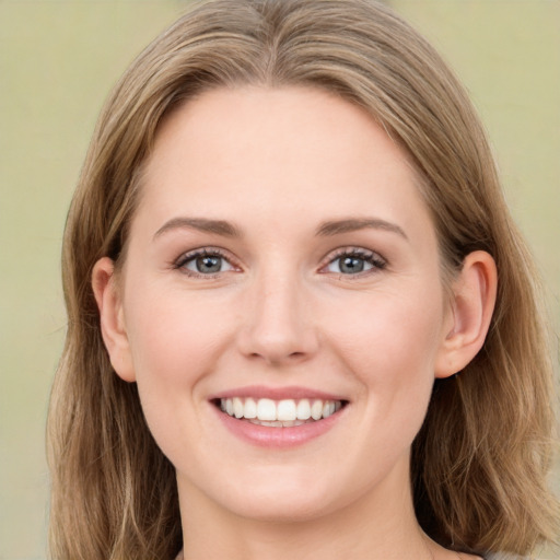 Joyful white young-adult female with long  brown hair and green eyes