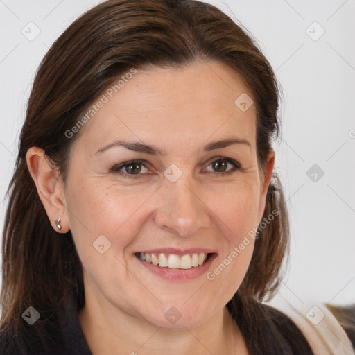 Joyful white adult female with long  brown hair and brown eyes