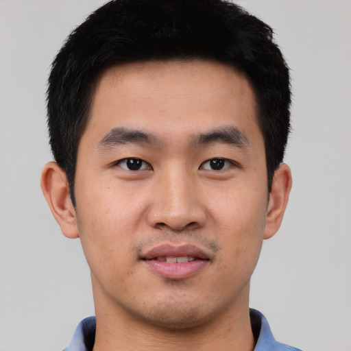 Joyful asian young-adult male with short  black hair and brown eyes