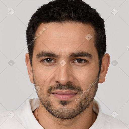 Joyful white young-adult male with short  black hair and brown eyes