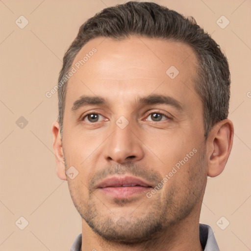 Joyful white adult male with short  brown hair and brown eyes