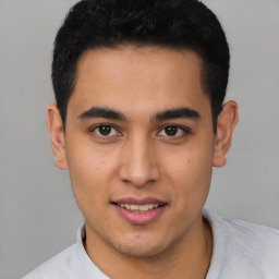 Joyful latino young-adult male with short  black hair and brown eyes