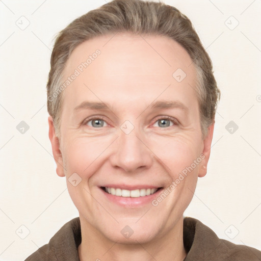 Joyful white adult male with short  brown hair and grey eyes