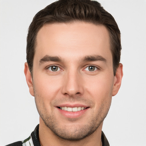 Joyful white young-adult male with short  brown hair and brown eyes