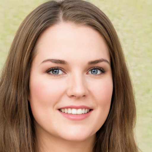 Joyful white young-adult female with long  brown hair and green eyes