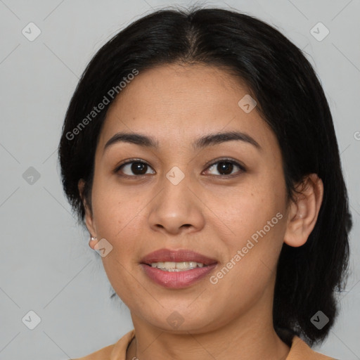 Joyful latino young-adult female with medium  brown hair and brown eyes